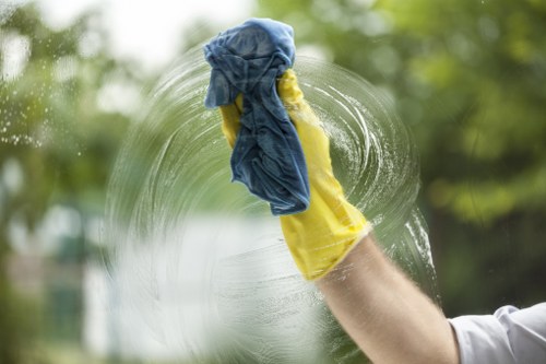 Cleaner wearing PPE while carrying out carpet cleaning work
